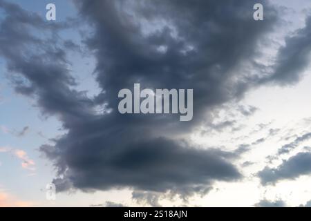 Low angle view of dark sky with strange shape of fluffy black clouds in the morning or evening while sunset or sunrise is used as natural background t Stock Photo