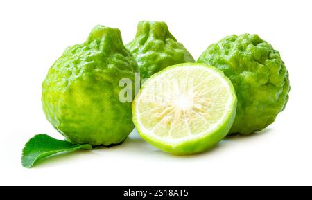 Three fresh green bergamot fruits or kaffir lime with half and green leaf in stack is isolated on white background with clipping path. Stock Photo