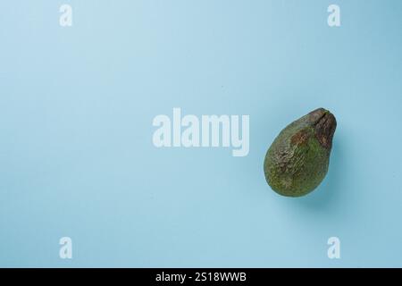 Top view of ripe avocado on blue background Stock Photo