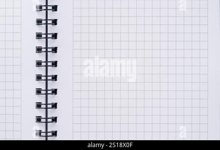 Top view of blank notebook page with black spiral and squares Stock Photo