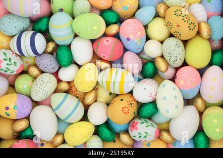 Easter egg background with colorful large collection of decorated and foil wrapped eggs. Design for holiday season, symbol of spring. Stock Photo