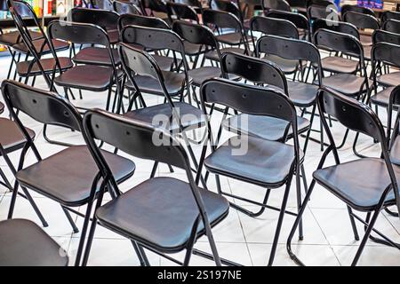 empty folding black chairs after the conference in the library interior Stock Photo