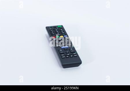 Black Wireless TV Remote Control Placed on a Clean White Surface Stock Photo