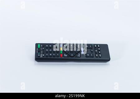 Black Wireless TV Remote Control Placed on a Clean White Surface Stock Photo