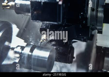 Cutting steel metal shaft processing on lathe machine in workshop, metalworking industry Stock Photo