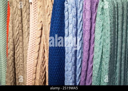 beautiful hand knitted multi-colored scarves and sweaters with a pattern Stock Photo