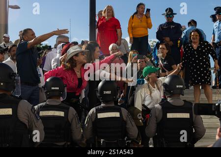 San Juan, USA. 02nd Jan, 2025. Environmental activists face off with police at the back entrance of the Puerto Rican Capitol Building during the government's swearing-in ceremony in San Juan, Puerto Rico on Jan. 1, 2025. (Carlos Berríos Polanco/Sipa USA) Credit: Sipa USA/Alamy Live News Stock Photo