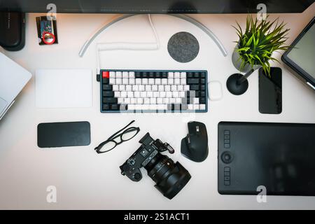 photographer graphic designer home studio equipment table digital camera tablet keyboard smartphone from above computer mouse Stock Photo