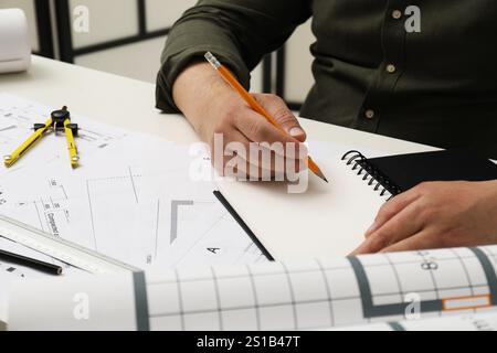 Architect working with project, closeup. Different technical drawings on white table Stock Photo