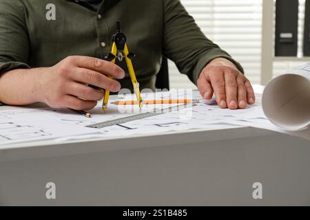 Architect working with project, closeup. Different technical drawings on table Stock Photo