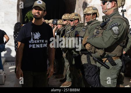 San Juan, USA. 02nd Jan, 2025. Environmental activists face off with police at the back entrance of the Puerto Rican Capitol Building during the government's swearing-in ceremony in San Juan, Puerto Rico on Jan. 2, 2025. (Carlos Berríos Polanco/Sipa USA) Credit: Sipa USA/Alamy Live News Stock Photo