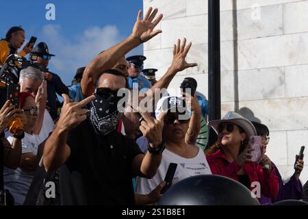 San Juan, USA. 02nd Jan, 2025. Environmental activists face off with police at the back entrance of the Puerto Rican Capitol Building during the government's swearing-in ceremony in San Juan, Puerto Rico on Jan. 2, 2025. (Carlos Berríos Polanco/Sipa USA) Credit: Sipa USA/Alamy Live News Stock Photo