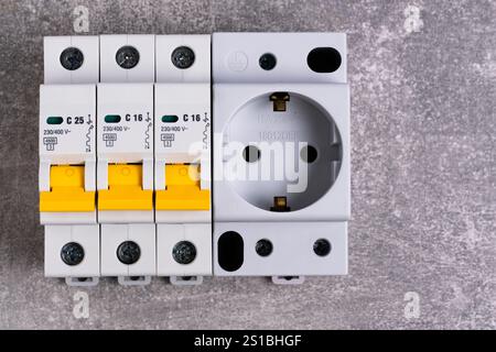 Electrical fuse box and socket on gray background. View from above. Copy space Stock Photo