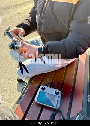 Man setting up drone prepare to be flying with remote radio controller on street Stock Photo