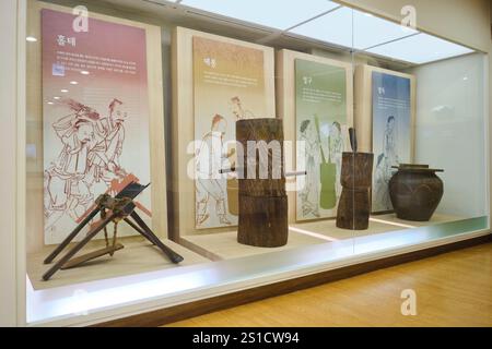 A display of old, wood processing tools and an interactive display. At ...