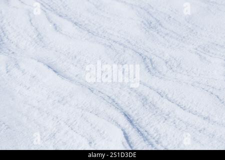 Natural diagonal wavy lines on surface of fresh white snow Stock Photo