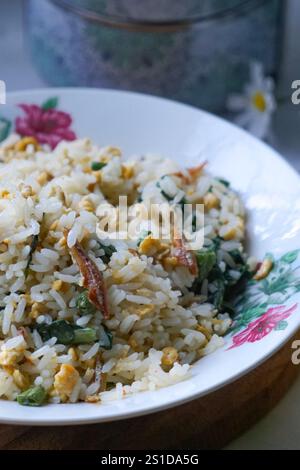 A plate of Fried Rice with chili, vegetable and anchovies or Nasi Goreng Kampung Stock Photo