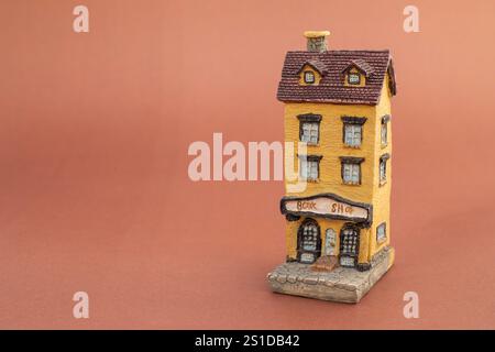 Miniature handmade house sculpture model for decoration on brown background Stock Photo