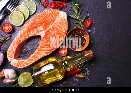 Salmon steak with lemon tomatoes and spices with olive oil Stock Photo