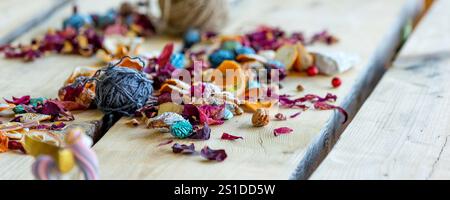 Roll of blue yarn thread for crafting lying on wooden table. Hobbies and craft materials theme. Stock Photo