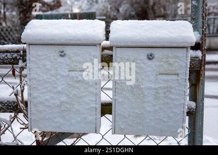 now-Covered German Mailboxes in a Picturesque Winter Scene Stock Photo