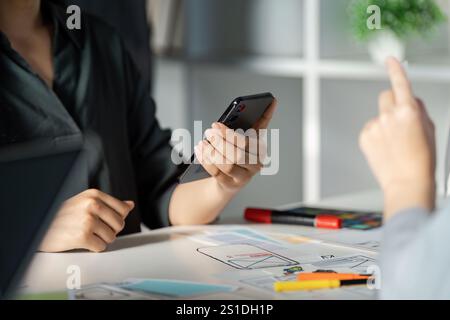 Creative UX UI Design Brainstorming Session with Mobile App Prototypes and Collaborative Teamwork Stock Photo