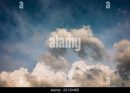 Fluffy White Clouds in a blue summer sky Stock Photo