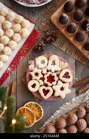 Selection of homemade Christmas cookies - Linzer, nuts, coconut balls and wasp nests or beehives, top view Stock Photo