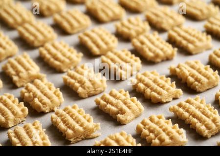Homemade raw Christmas cookies on parchment paper before baking, closeup Stock Photo