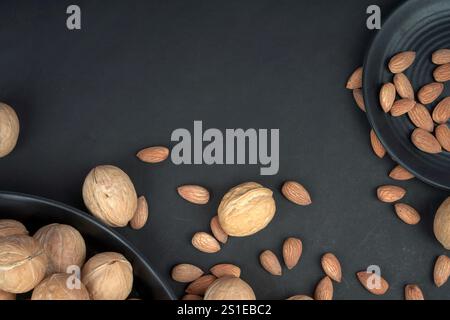 In black background fresh almonds and walnut photo are taken Stock Photo