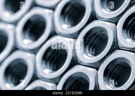Metal nuts in a row background. Chromed screw nuts. Steel nuts pattern. Tools for work. Stock Photo