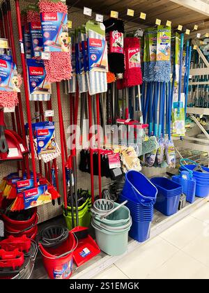 Kyiv, Ukraine - January 03, 2025: A well-organized store aisle featuring various cleaning supplies including mops, buckets, and brushes, showcasing pr Stock Photo