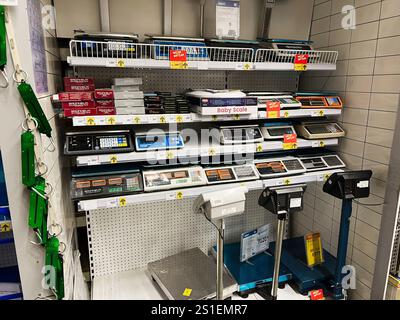 Kyiv, Ukraine - January 03, 2025: Various digital and mechanical scales for personal and commercial use organized on store shelves. Stock Photo