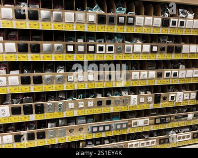 Kyiv, Ukraine - January 03, 2025: A neatly organized store display showing a wide variety of electrical switches and sockets, highlighting different d Stock Photo