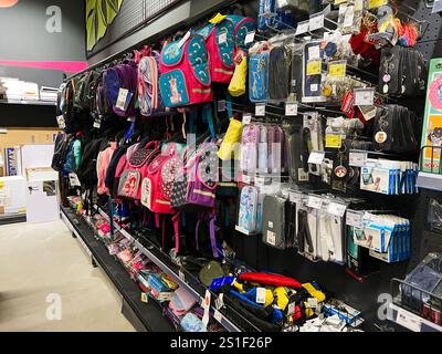 Kyiv, Ukraine - January 03, 2025: Various colorful backpacks and school accessories are neatly arranged on shelves in a store display, offering a vari Stock Photo