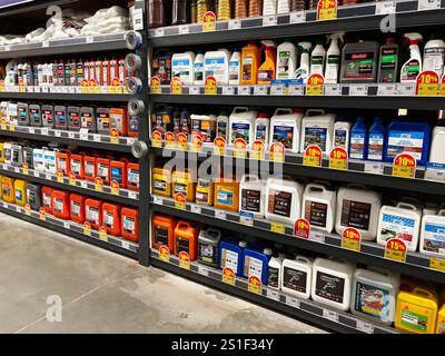 Kyiv, Ukraine - January 03, 2025: An aisle of a store showcasing bottles of oils, detergents, and solutions on shelves with price labels. These produc Stock Photo