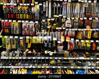 Kyiv, Ukraine - January 03, 2025: A wide range of tools including pliers, screwdrivers, and hand saws neatly arranged for sale in a retail hardware st Stock Photo