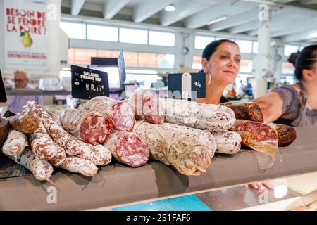Cannes France,Provence Alpes Cote d’Azur,Marche Forville traditional market,marketplace shopping,woman female vendor,saucisson sausage selection,salam Stock Photo