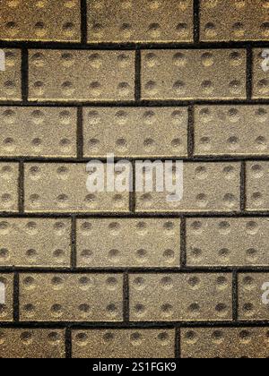 Background from a brick wall of mustard color and with dark seams Stock Photo