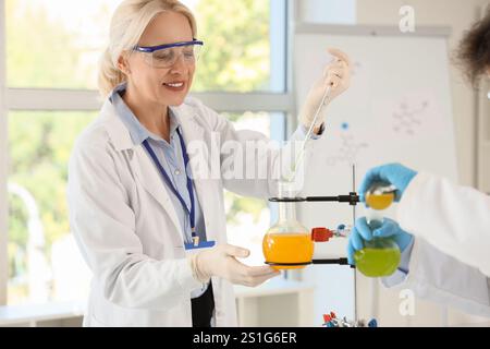 Female chemist conducting experiment in laboratory Stock Photo