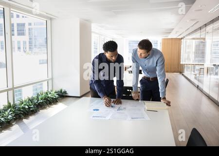 Focused busy multiethnic male professionals working on project Stock Photo