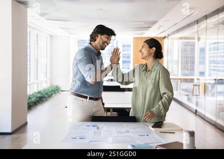 Happy couple of Indian business colleagues giving high five Stock Photo