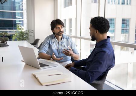 Diverse project managers discussing work strategy, planning teamwork Stock Photo