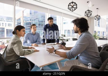 Diverse team of young managers working on startup together Stock Photo