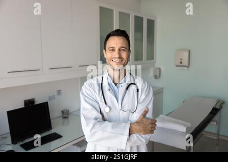 Happy doctor man standing for portrait with arms folded Stock Photo