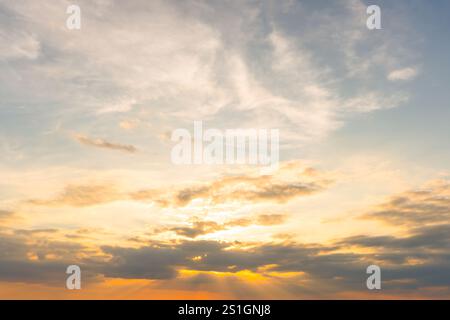 Beautiful morning or evening orange or yellow and blue sky with cloudy when sunset or sunrise is used as natural background texture. Stock Photo