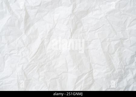 Top view and full frame of wrinkled or crumpled white stencil paper texture is used for wrinkled or crumpled white paper background texture. Stock Photo