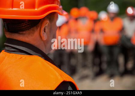 Working together. Worker group wearing vest, safety. Builder man. Helmet builder, hardhat for work. Professional team and portrait of an engineer Stock Photo