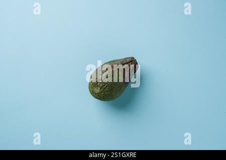 Top view of ripe avocado on blue background Stock Photo