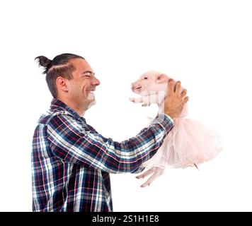 pink miniature pig and man in front of white background Stock Photo